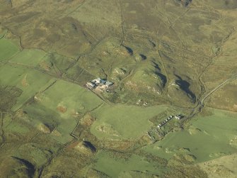 Oblique aerial view centred on the remains of the township with the farmsteading adjacent, taken from the ESE.