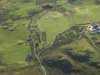 Oblique aerial view centred on the remains of the township with the farmsteading adjacent, taken from the NNW.
