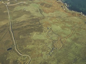 Oblique aerial view centred on the remains of the township and rig, taken from the W.