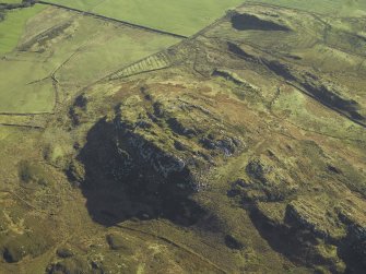 Oblique aerial view centred on the remains of the fort, taken from the NW.