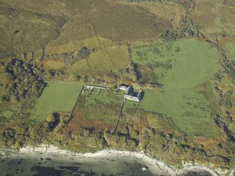 Oblique aerial view centred on the farmhouse, farmsteading and walled garden, taken from the SE.