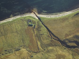 Oblique aerial view centred on the remains of the cottage, rig and sheepfold, taken from the NW.