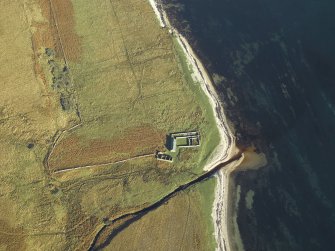 Oblique aerial view centred on the remains of the cottage, rig and sheepfold, taken from the SW.