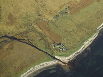 Oblique aerial view centred on the remains of the cottage, rig and sheepfold, taken from the SE.