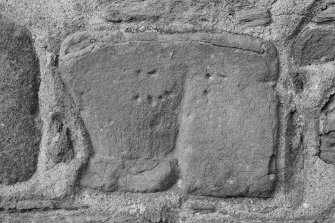 Detail of carved fragment set into church wall