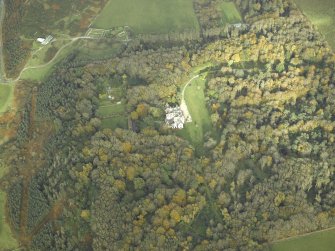Oblique aerial view centred on the country house and walled garden with the remains of the church and burial-ground adjacent, taken from the SW.