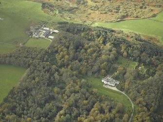 Oblique aerial view centred on the country house with the farmsteading and farmhouse adjacent, taken from the E.