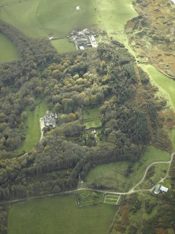 General oblique aerial view centred on the country house and walled garden with the farmsteading and farmhouse and remains of the church and burial-ground adjacent, taken from the NNE.