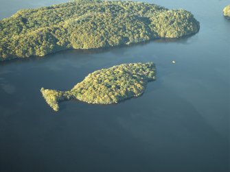 General oblique aerial view centred on the remains of the crannog and the islands, taken from the SE.