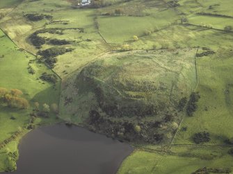 Oblique aerial view centred on the remains of the fort, taken from the WNW.