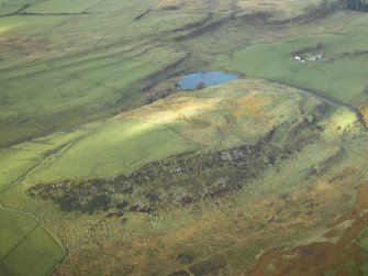 Oblique aerial view centred on the remains of the fort, taken from the ESE.