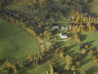 Oblique aerial view centred on the country house, stables and walled garden, taken from the ESE.