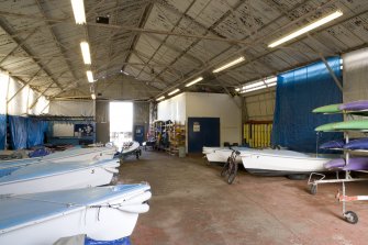 Interior.  Boat repair hangar, boat storage and workshop from SW.