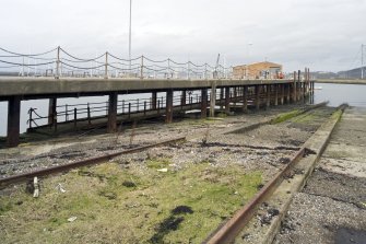 View.  Showing slipway adjacent to the rope splicing table and the S end of the E pier with Loop Shed in mid-distance.