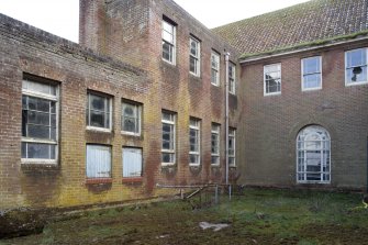 View.  Part of central area of Sandhurst Barrack Block showing access hatches and metal framed windows.