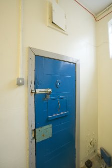 Interior.  Detail of cell door with peep hole.