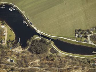 Oblique aerial view centred on the lock, canal and cottages, taken from the NW.