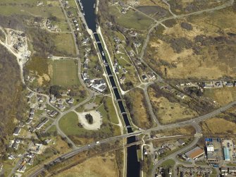Oblique aerial view centred on the canal at Neptune's Staircase, locks, swing bridges and railway bridge, taken from the SW.