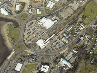Oblique aerial view centred on the railway depot, church and hospital, taken from the SW.