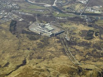 Oblique aerial view centred on the aluminium works, penstocks and electricity generating station, taken from the ESE.