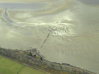 Oblique aerial view centred on the remains of the fish trap, taken from the WNW.