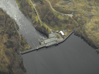 Oblique aerial view centred on the dam and electricity generating station, taken from the NW.
