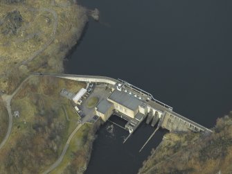 Oblique aerial view centred on the dam and electricity generating station, taken from the ENE.
