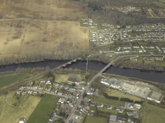 Oblique aerial view centred on the road bridge, railway viaduct and pipe bridge, taken from the ESE.