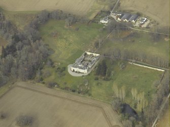 Oblique aerial view centred on the country house, farmhouse and farmsteading, taken from the E.
