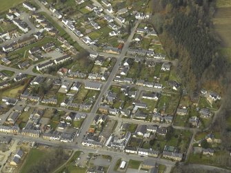 Oblique aerial view of the village centred on the church, taken from the E.