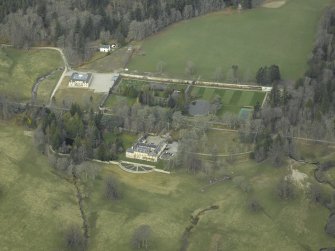 Oblique aerial view centred on the country house and walled gardens, taken from the SE.