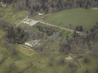 Oblique aerial view centred on the country house and walled gardens, taken from the ESE.