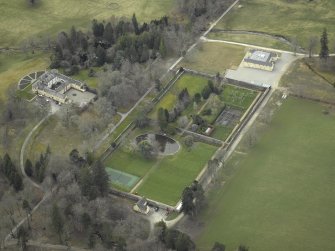 Oblique aerial view centred on the country house and walled gardens, taken from the NNE.