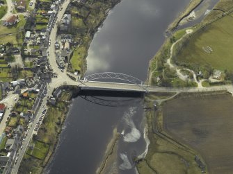 Oblique aerial view centred on the road bridge with the hotel adjacent, taken from the NW.