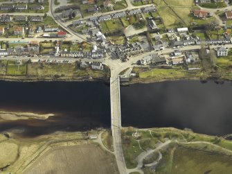 Oblique aerial view centred on the road bridge with the hotel adjacent, taken from the WSW.