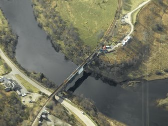 Oblique aerial view centred on the railway viaduct with the railway station adjacent, taken from the NE.