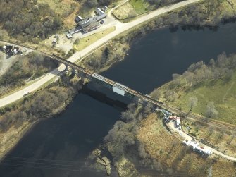 Oblique aerial view centred on the railway viaduct with the railway station adjacent, taken from the WNW.