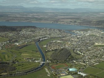 General oblique aerial view of the town centred on the cemetery and the swing bridge, taken from the SSE.