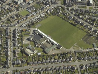 Oblique aerial view centred on the school, taken from the W.