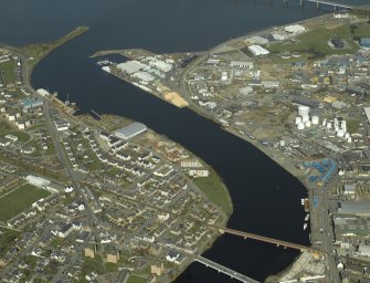 General oblique aerial view centred on the railway viaduct and shipyard with the harbour and road bridge adjacent, taken from the SSW.