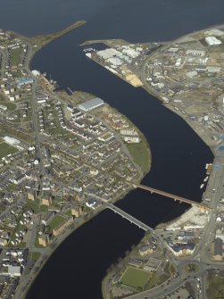 General oblique aerial view centred on the railway viaduct and shipyard with the harbour and road bridge adjacent, taken from the S.