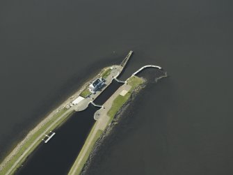 Oblique aerial view centred on the lock, house, piers and beacons, taken from the ENE.