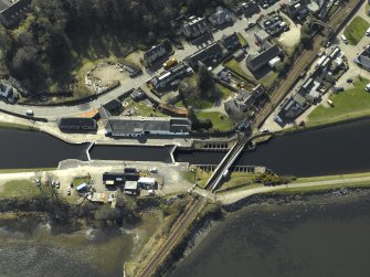 Oblique aerial view centred on the lock, swing bridge and workshops, taken from the NE.