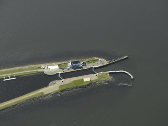 Oblique aerial view centred on the lock, house, piers and beacons, taken from the NNE.