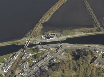 Oblique aerial view centred on the lock, swing bridge and workshops, taken from the SW.
