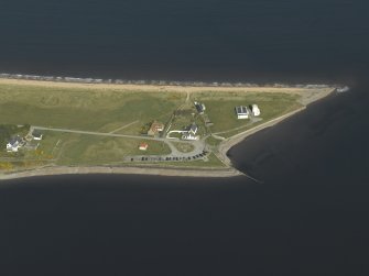 Oblique aerial view centred on the lighthouse, cottages and ferry house, taken from the SW.