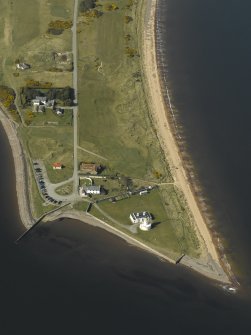 Oblique aerial view centred on the lighthouse, cottages and ferry house, taken from the SE.