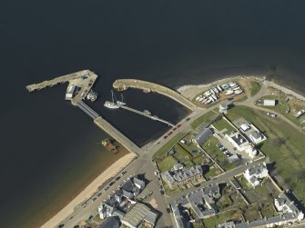Oblique aerial view centred on the harbour and the lighthouse, taken from the SE.