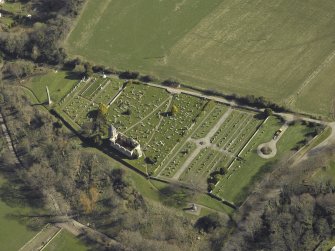 Oblique aerial view centred on the chapel, burial-ground and monument, taken from the NW.