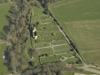 Oblique aerial view centred on the chapel, burial-ground and monument, taken from the WSW.